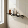 black toughened (80cmx10cm) Glass shelf with bathroom products against a tiled wall