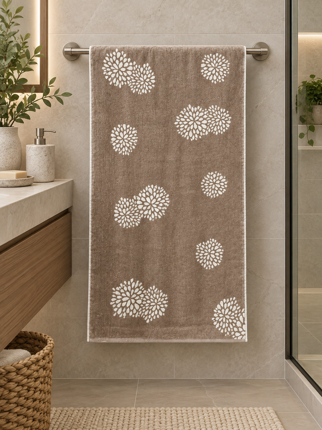 Brown bath towel with white floral motifs hanging in a contemporary bathroom