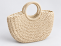 Cream braided tote bag with rope handles on a light gray studio background