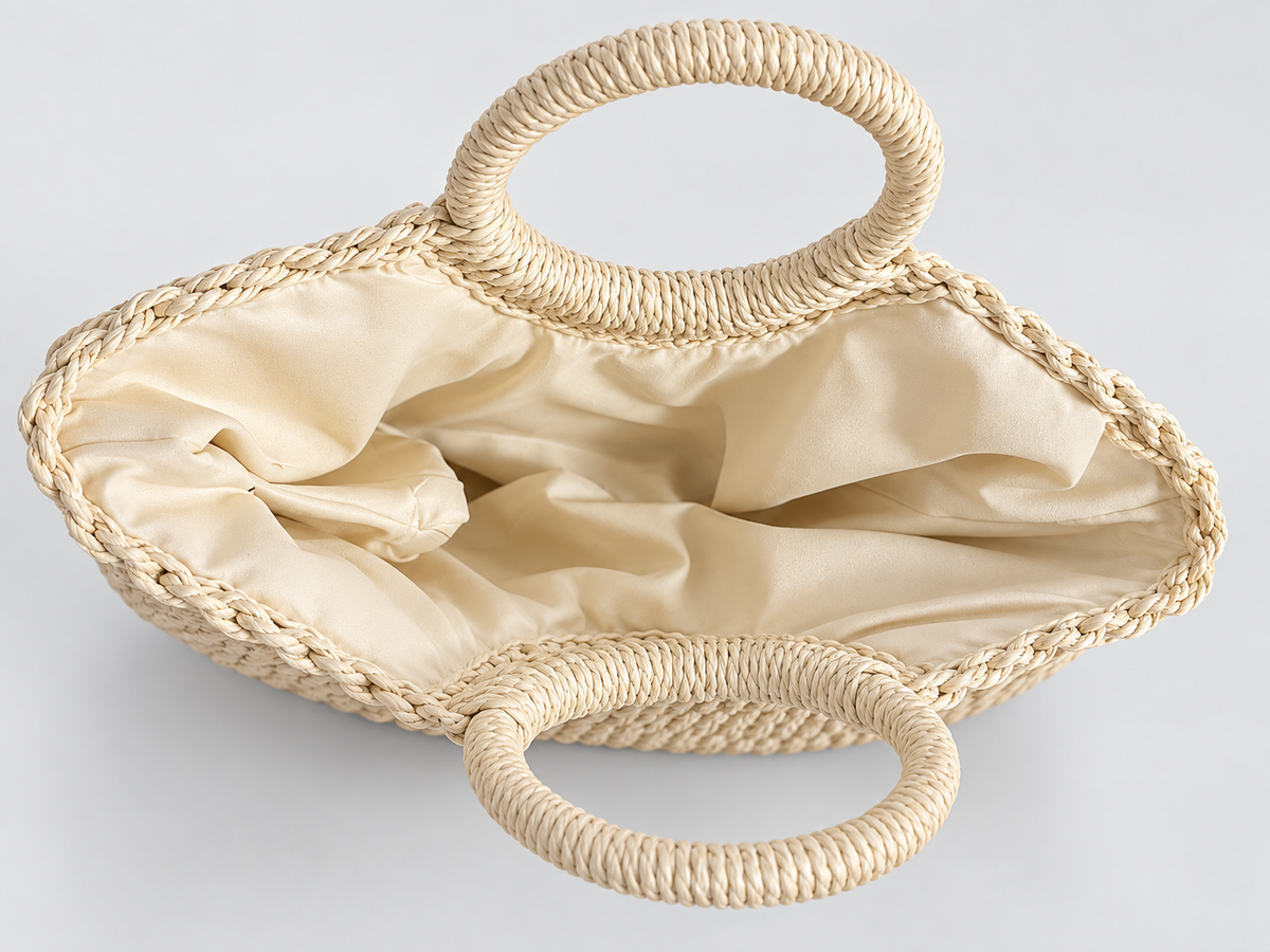 Open cream braided tote bag showing its smooth fabric lining