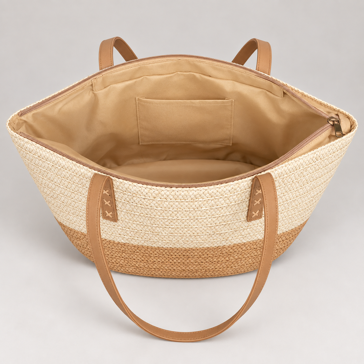Open tapered woven tote showing beige lining and slip pocket