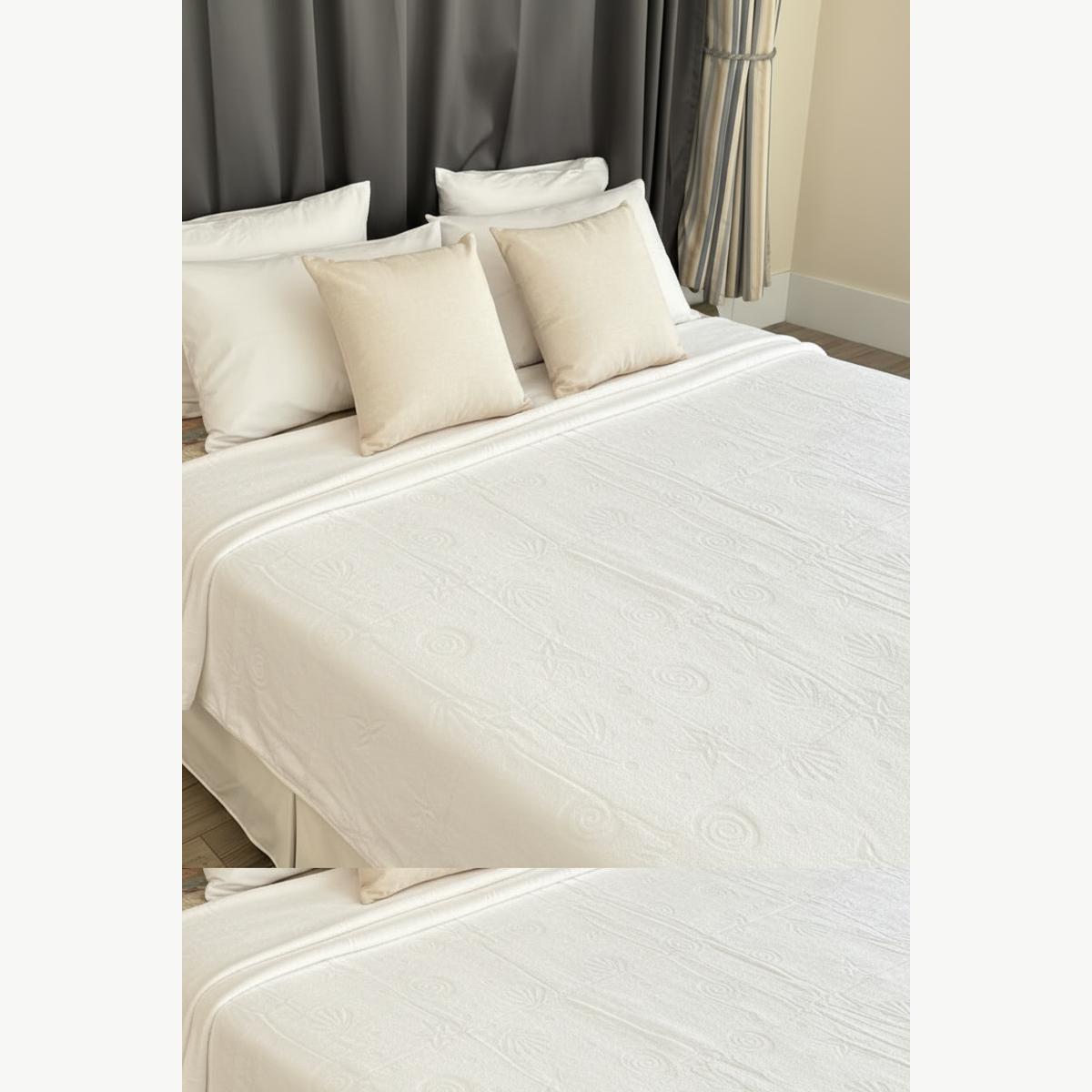 White cotton terry bedspread draped over a white bed in a luxury bedroom setting