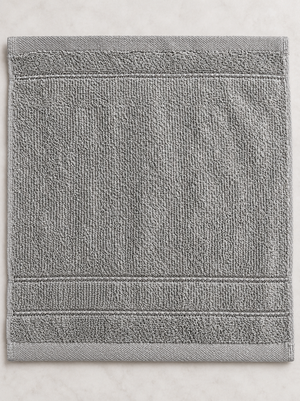 Close-up of the subtle woven bands and texture on a medium gray Design Republique face cloth