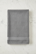 Grey Bath Towel folded flat on marble surface