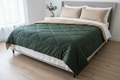 Dark green and beige reversible quilted duvet styled on a bed