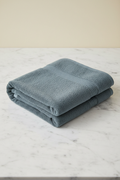 M&D Decor Heavy Grey Bath Towel folded flat on marble surface