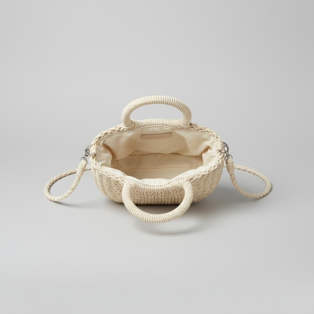 Open cream woven straw bag showing its plain smooth cream fabric lining