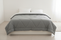 Grey cotton-outer lightweight duvet styled on a bed