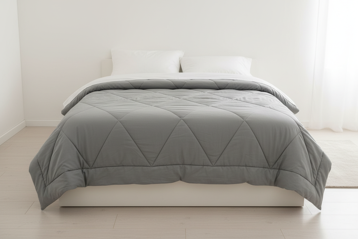 Grey cotton-outer lightweight duvet styled on a bed