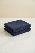 Blue Bath Towel folded flat on marble surface