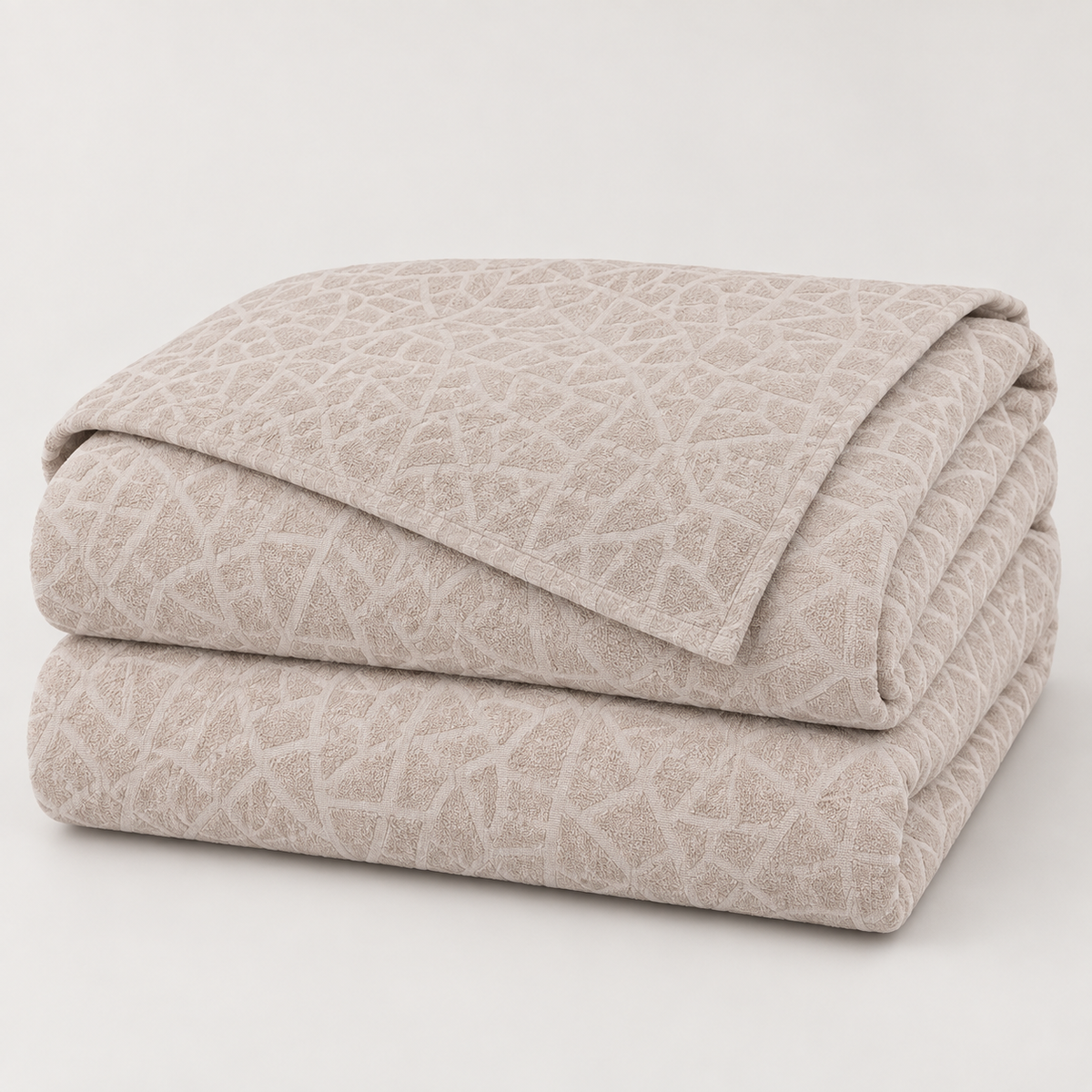 Pale blush beige mosaic textured bedspread 200 x 210 cm folded studio view