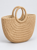 Natural braided tote bag with rope handles on a light gray studio background