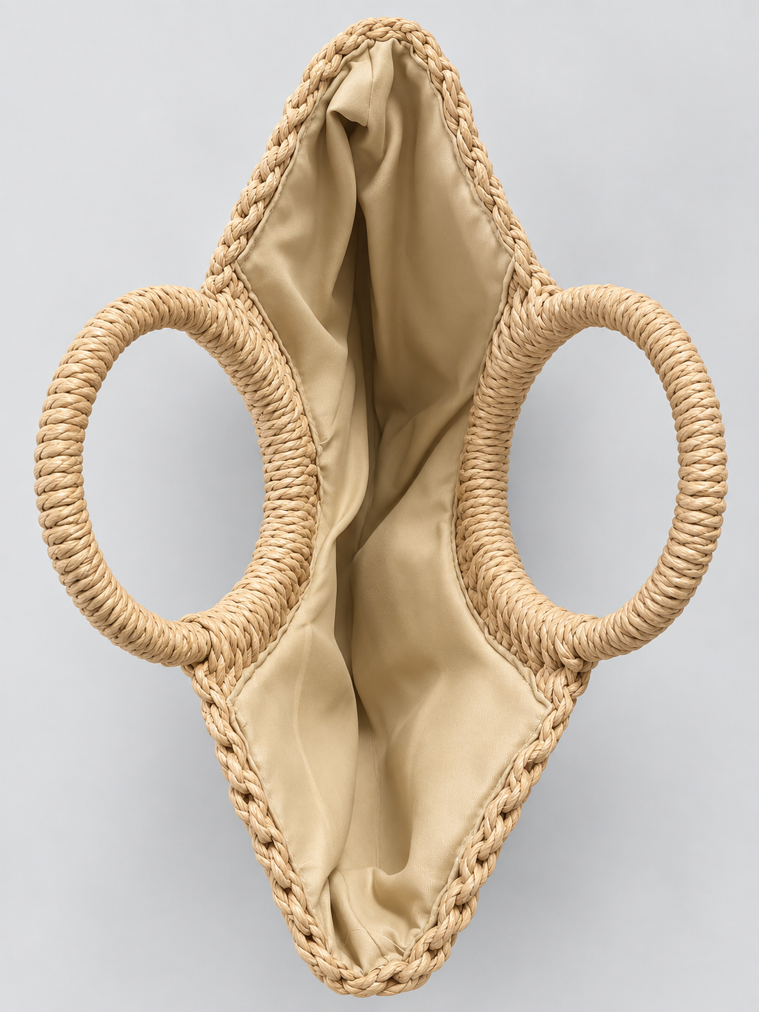 Open natural braided tote bag showing cream fabric lining
