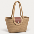 Tan rope tote bag with dusty rose flap and pearl-style snap on a light gray studio background