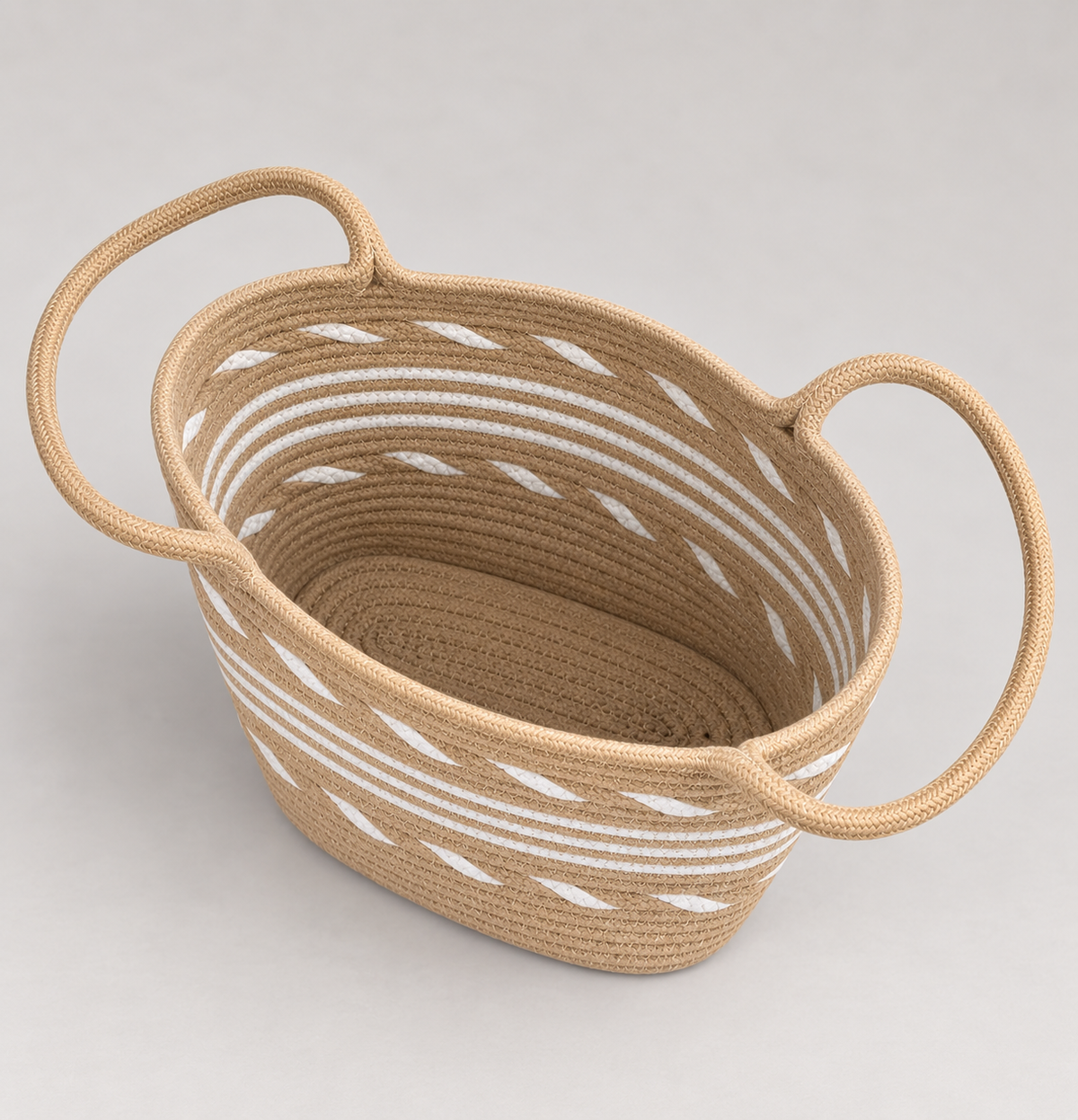 Open tan and white coiled rope tote showing unlined interior